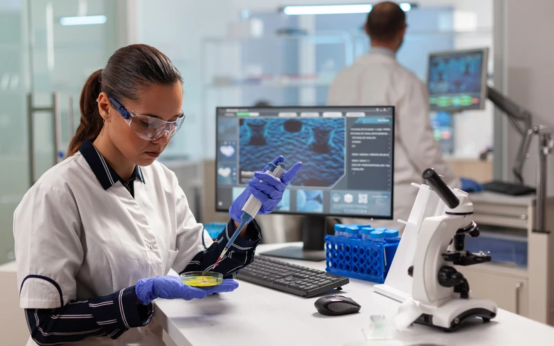 doctor-scientist-conducting-clinical-experiment-using-micropipette